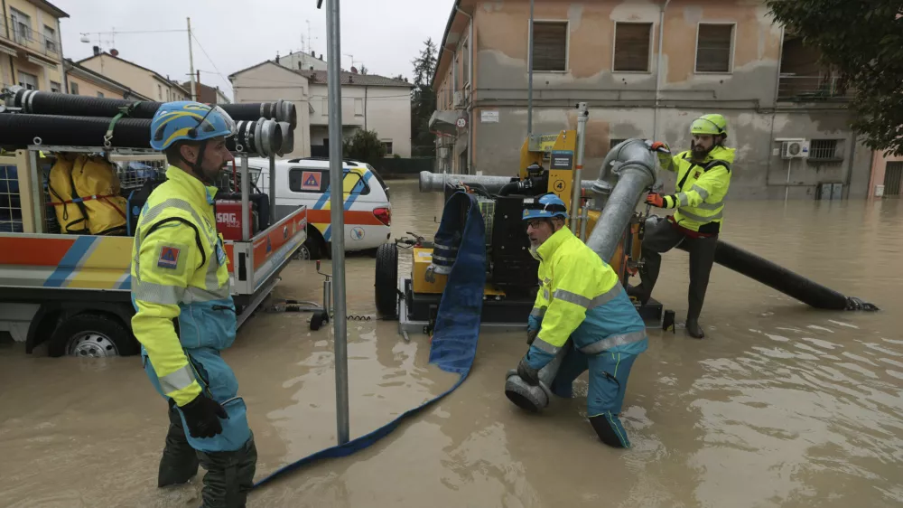 Workers try to pump away water after flooding in Faenza, in the region of Emilia Romagna, Italy, Thursday, Sept. 19, 2024. (Fabrizio Zani/LaPresse via AP)