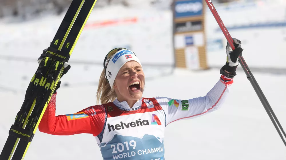 06 March 2021, Bavaria, Oberstdorf: Norway's Therese Johaug celebrates as she crosses the finish line to win the Women's Mass Start 30km Classic cross country race at the FIS Nordic Ski World Championships. Photo: Karl-Josef Hildenbrand/dpa