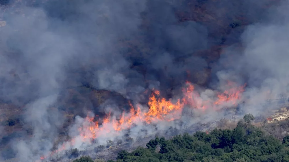 Flames and smoke rise from an Israeli airstrike on the Mahmoudieh mountain, as seen from Marjayoun town, south Lebanon, Tuesday, Sept. 24, 2024. (AP Photo/Hussein Malla)