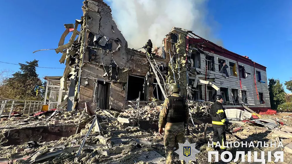 A firefighter extinguishes a fire on a damaged building after a Russian attack in the Donetsk region of Ukraine, Tuesday Sept. 24, 2024. (Ukraine National Police via AP)