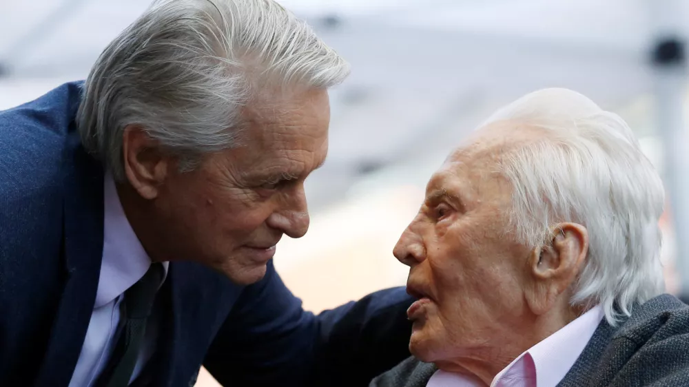 FILE PHOTO: Actor Kirk Douglas talks with his son actor Michael Douglas prior to the unveiling of Michael Douglas' star on the Hollywood Walk of Fame in Los Angeles, California, U.S., November 6, 2018. REUTERS/Mario Anzuoni/File Photo