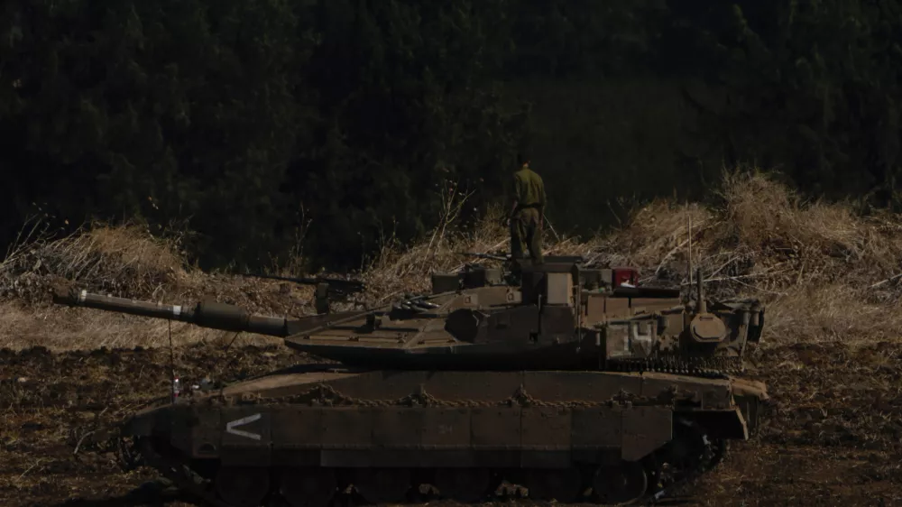 Israeli soldiers work on tanks in northern Israel on Sunday, Sept. 29, 2024. (AP Photo/Ariel Schalit)