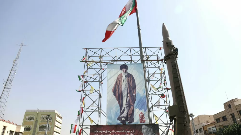 FILE PHOTO: An Iranian missile system is displayed next to a banner with a picture of Iran's Supreme Leader Ayatollah Ali Khamenei and the late Lebanon's Hezbollah leader Hassan&nbsp;Nasrallah, in a street in Tehran, Iran, October 2, 2024. Majid Asgaripour/WANA (West Asia News Agency) via REUTERS ATTENTION EDITORS - THIS IMAGE HAS BEEN SUPPLIED BY A THIRD PARTY/File Photo