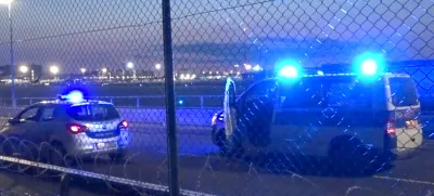 25 July 2024, Hesse, Frankfurt/Main: Police vehicles are parked near the tarmac at Frankfurt Airport. Air traffic has been temporarily suspended due to an action by climate activists. Photo: Mike Seeboth/TNN/dpa