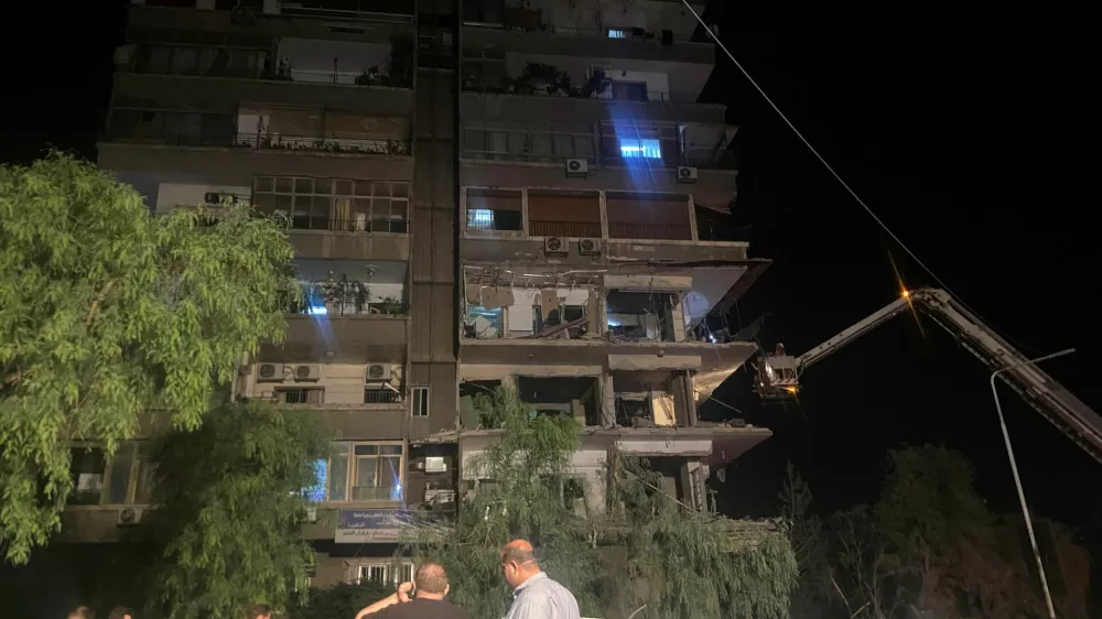 Rescuers work at the site of an Israeli airstrike that targeted a residential building in the Mezzah suburb west of the Syrian capital Damascus, Syria's state news agency reported, Syria October 8, 2024. REUTERS/Firas Makdesi