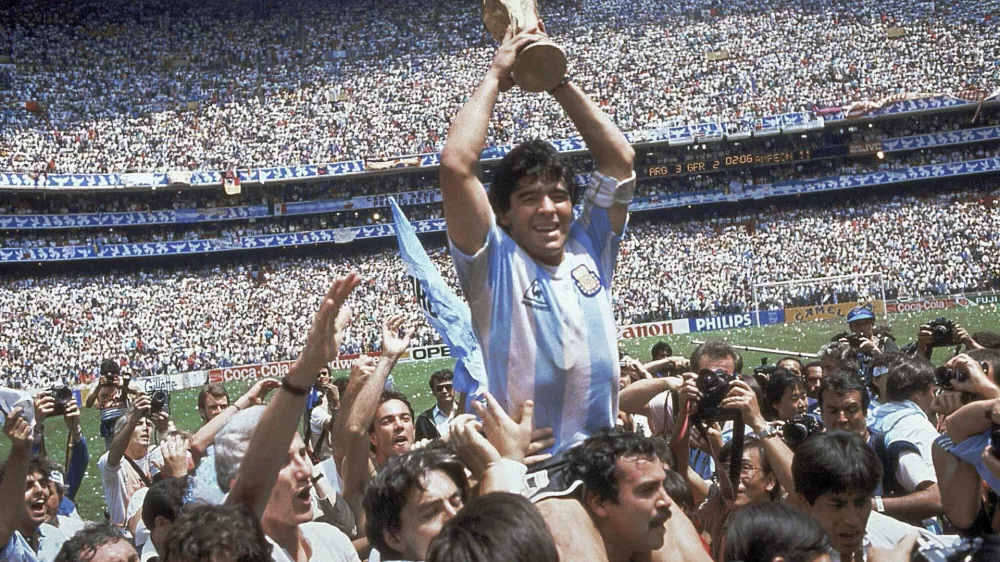 FILE - In this June 29, 1986, file photo, Diego Maradona holds up his team's trophy after Argentina's 3-2 victory over West Germany at the World Cup final soccer match at Azteca Stadium in Mexico City. The Argentine soccer great who was among the best players ever and who led his country to the 1986 World Cup title died from a heart attack on Wednesday, Nov. 25, 2020, at his home in Buenos Aires. He was 60. (AP Photo/Carlo Fumagalli, File)