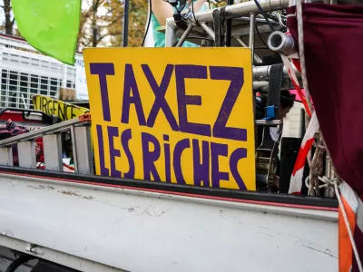 France, Paris, 2024/10/01. Inter-professional demonstration in Paris and throughout France for wages, public services and the repeal of pension reform. A sign reading tax the rich on a lorry. Photography by Myriam Tirler / Hans Lucas.France, Paris, 2024/10/01. Manifestation interprofessionelle Paris et dans toute la France pour les salaires, les services publics et l'abrogation de la reforme des retraites. Une pancarte ou est ecrit taxez les riches sur un camion. Photographie de Myriam Tirler / Hans Lucas.