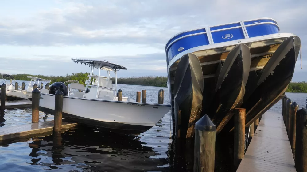 Small boats rests on a pier after they were unmoored during Hurricane Milton, Thursday, Oct. 10, 2024, in Fort Myers, Fla. (AP Photo/Marta Lavandier)