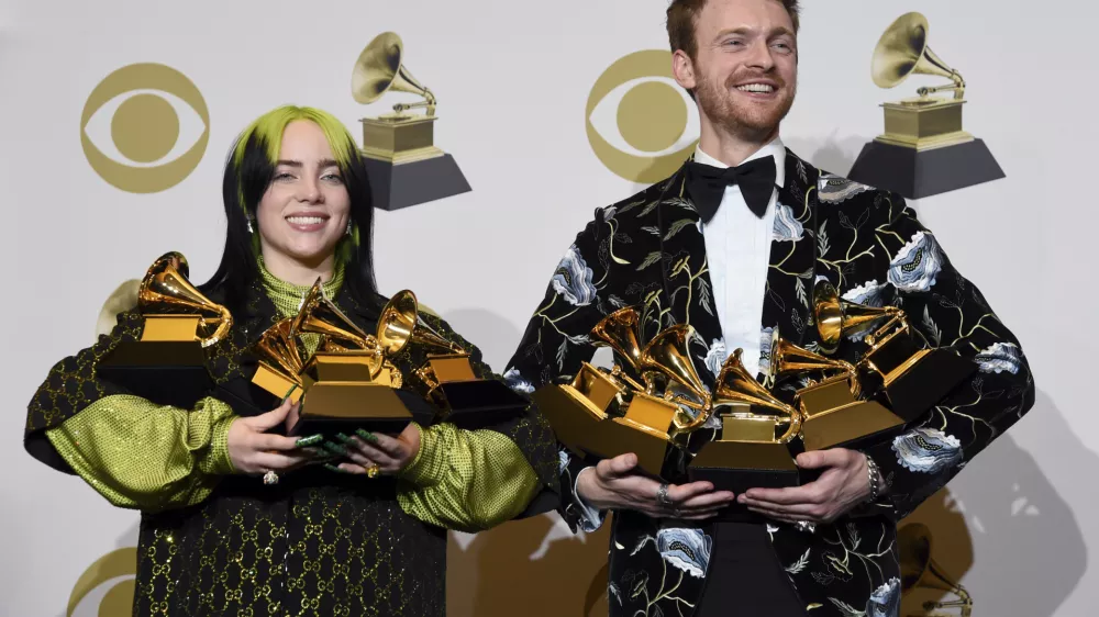 Billie Eilish, left, and Finneas O'Connell pose in the press room with the awards for best album, best engineered album and best pop vocal album for "We All Fall Asleep, Where Do We Go?," best song and record for "Bad Guy," best new artist and best producer, non-classical at the 62nd annual Grammy Awards at the Staples Center on Sunday, Jan. 26, 2020, in Los Angeles. (AP Photo/Chris Pizzello)