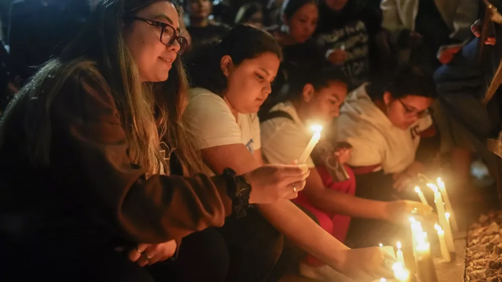Fans light candles outside the hotel where former One Direction singer Liam Payne was found dead after he fell from a balcony in Buenos Aires, Argentina, Wednesday, Oct. 16, 2024. (AP Photo/Natacha Pisarenko)