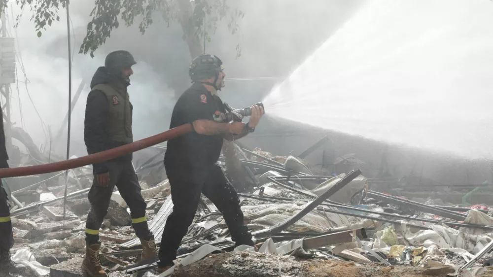 Civil defence members put out a fire at a damaged site, in the aftermath of Israeli strikes on Beirut's southern suburbs, Lebanon October 20, 2024. REUTERS/Ali Alloush