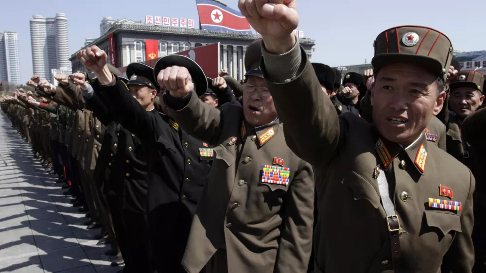 North Korean army officers punch the air as they chant slogans during a rally at Kim Il Sung Square in downtown Pyongyang, North Korea, Friday, March 29, 2013. Tens of thousands of North Koreans turned out for the mass rally at the main square in Pyongyang in support of their leader Kim Jong Un's call to arms. (AP Photo/Jon Chol Jin)
