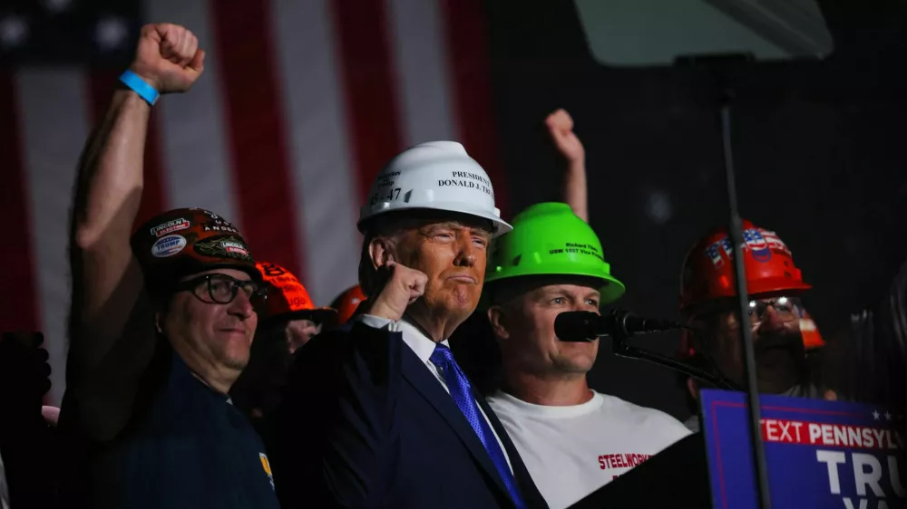 Endorsed by steel workers onstage, Republican presidential nominee and former U.S. President Donald Trump wears a hard hat during his Make America Great Again Rally in Latrobe, Pennsylvania, U.S. October 19, 2024. REUTERS/Brian Snyder