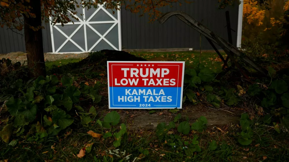 A sign supporting former U.S. president Donald Trump stands posted in the election battleground Erie County township of North East, Pennsylvania, U.S., October 23, 2024. REUTERS/Shannon Stapleton