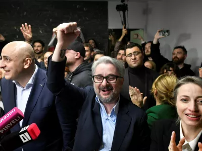 Nika Melia and Nika Gvaramia, leaders of the Coalition for Change, and Nana Malashkhia, who leads the coalition's parliament list, react after the announcement of exit poll results in parliamentary elections, in Tbilisi, Georgia October 26, 2024. REUTERS/Zurab Javakhadze