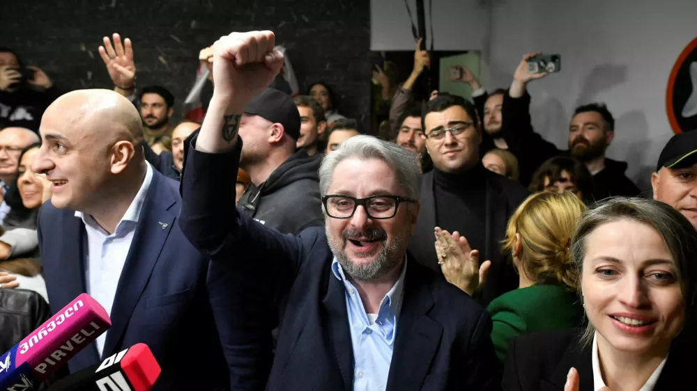 Nika Melia and Nika Gvaramia, leaders of the Coalition for Change, and Nana Malashkhia, who leads the coalition's parliament list, react after the announcement of exit poll results in parliamentary elections, in Tbilisi, Georgia October 26, 2024. REUTERS/Zurab Javakhadze