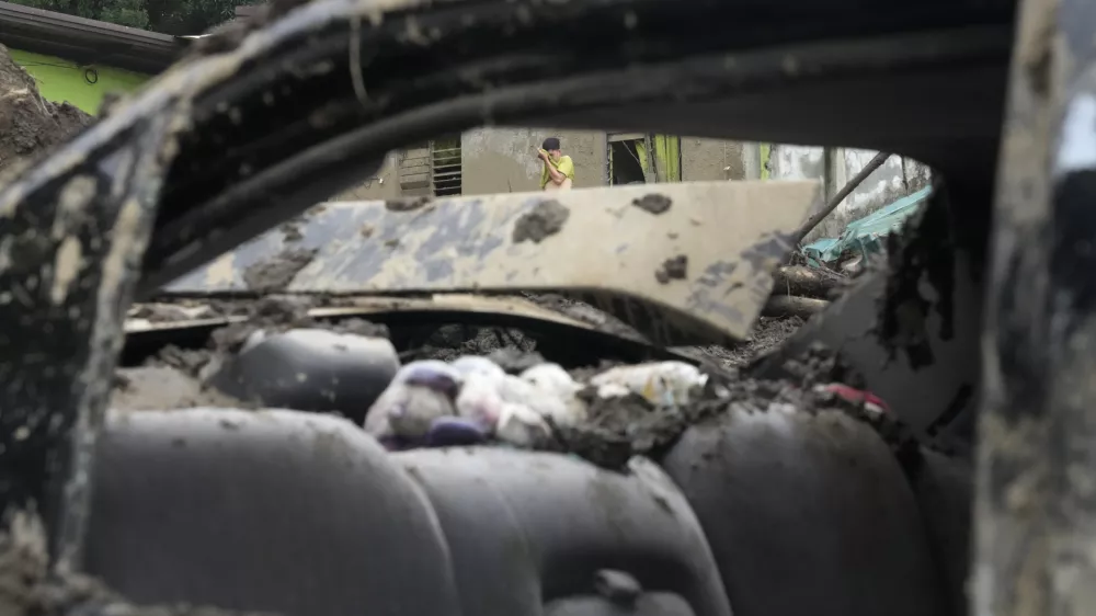 A man wipes sweat as he joins retrieval operations after a landslide triggered by Tropical Storm Trami struck homes leaving several villagers dead in Talisay, Batangas province, Philippines on Saturday, Oct. 26, 2024. (AP Photo/Aaron Favila)