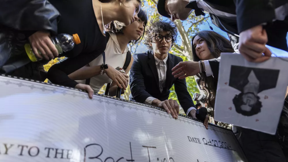 Anthony Po, right, deliberates with the judges at the Timothee Chalamet lookalike contest near Washington Square Park, Sunday, Oct. 27, 2024, in New York. (AP Photo/Stefan Jeremiah)