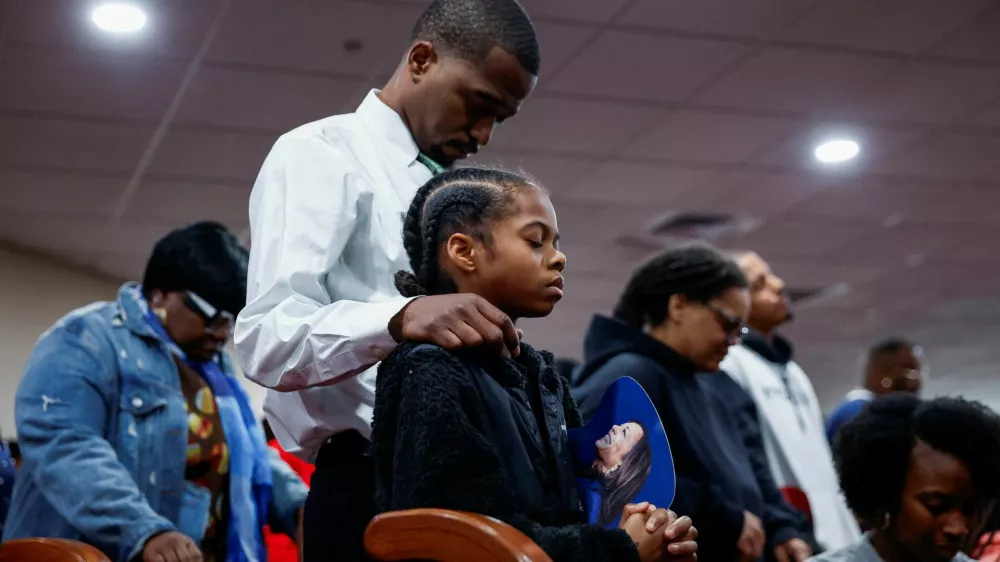 A child holds an image of Democratic presidential nominee U.S. Vice President Kamala Harris on the day of her visit at the Church of Christian Compassion, part of the "Souls to the Polls", as she campaigns in Philadelphia, Pennsylvania, U.S. October 27, 2024. REUTERS/Evelyn Hockstein   TPX IMAGES OF THE DAY