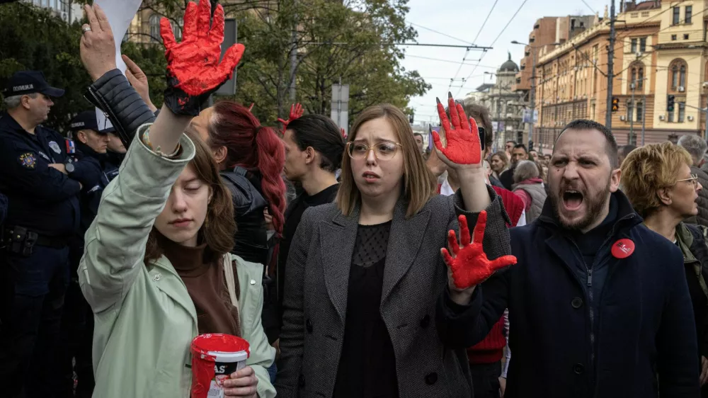 Demonstrators show their hands painted in red as they protest to commemorate an accident at a railway station in the Serbian city of Novi Sad, for which they blame negligence and corruption by the authorities, in front of the government in Belgrade, Serbia November 3, 2024. REUTERS/Marko Djurica