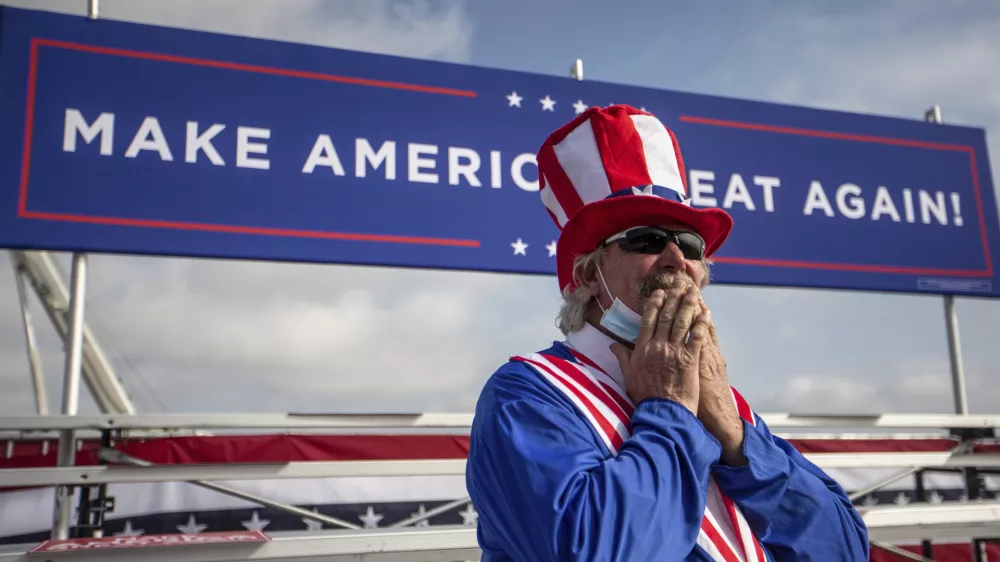 Phil Eason wears an Uncle Sam costume during the Make America Great Again Victory rally with Vice President Mike Pence at the Piedmont Triad International Airport in Greensboro, N.C., on Tuesday, Oct. 27, 2020. (Khadejeh Nikouyeh/News & Record via AP)