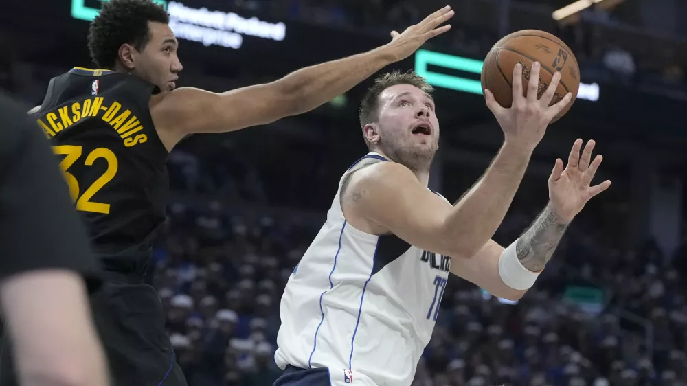 Luka Dončić (z žogo) in soigralci iz Dallasa so proti ekipi Golden State Warriors doživeli že &scaron;esti poraz v leto&scaron;nji sezoni. Foto: AP