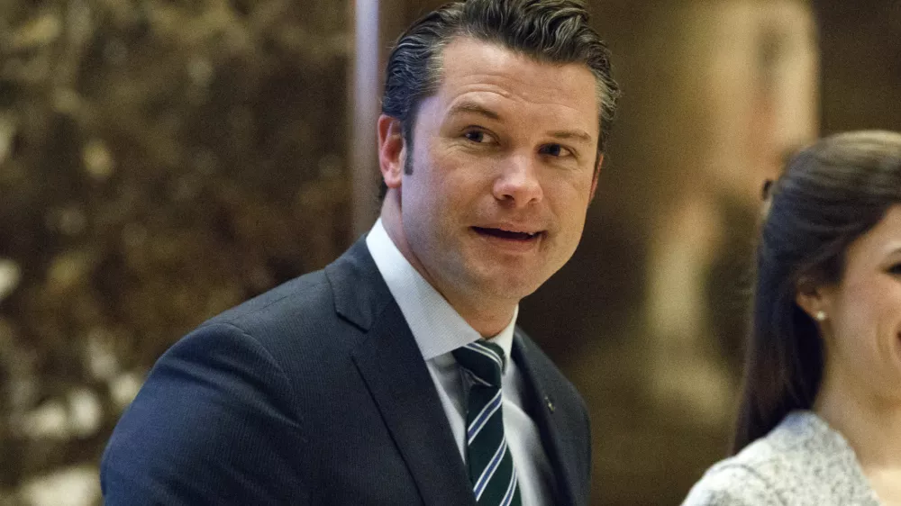FILE - Pete Hegseth walks to an elevator for a meeting with President-elect Donald Trump at Trump Tower in New York, Dec. 15, 2016. (AP Photo/Evan Vucci, File)