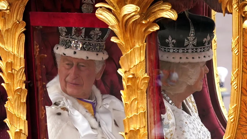 06 May 2023, United Kingdom, London: King Charles III (L)&nbsp;and Queen Camilla are carried in the Gold State Coach, pulled by eight Windsor Greys, in The Coronation Procession as they return along The Mall to Buckingham Palace, London, following their coronation ceremony. Photo: Niall Carson/PA Wire/dpa