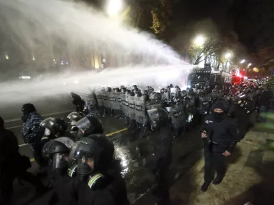 Police use a water cannon to prevent protesters pouring into the streets following Georgian Prime Minister Irakli Kobakhidze's announcement, rallying outside the parliament building in Tbilisi, Georgia, on Friday, Nov. 29, 2024. (AP Photo/Zurab Tsertsvadze)