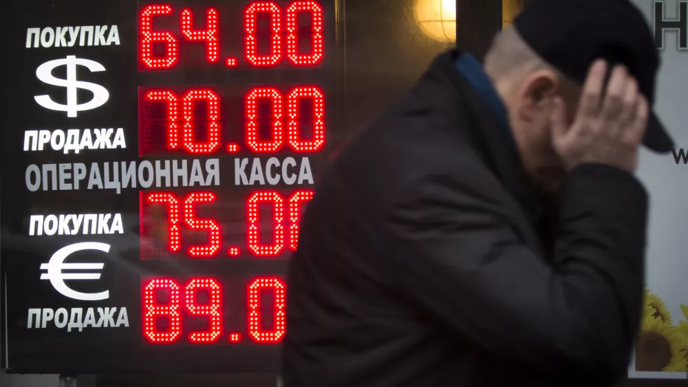 Signs advertising currencies light next to the exchange office in Moscow, Russia, Tuesday, Dec. 16, 2014. After a massive overnight rate hike by Russia's Central Bank, the ruble staged a two-hour rally Tuesday morning before rolling back to new historic lows. The surprise Central Bank decision to raise the rate to 17 percent from 10.5 percent came in the early hours on Tuesday in a desperate attempt to prop up the troubled currency. It's the biggest interest rate hike since 1998, the year when Russia defaulted on its sovereign bonds.(AP Photo / Alexander Zemlianichenko)