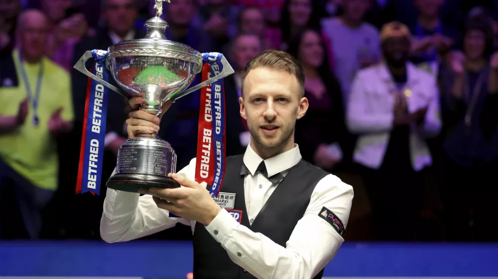 Britain's Judd Trump lifts the trophy after winning the 2019 Snooker World Championship after beating Scotland's John Higgins, at The Crucible, in Sheffield, England, Monday May 6, 2019. (Richard Sellers/PA via AP)