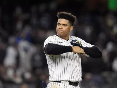 FILE - New York Yankees' Juan Soto takes off his batting gloves after grounding out against the New York Yankees to end the third inning in Game 3 of the baseball World Series, on Oct. 28, 2024, in New York. (AP Photo/Godofredo A. V&aacute;squez, File)