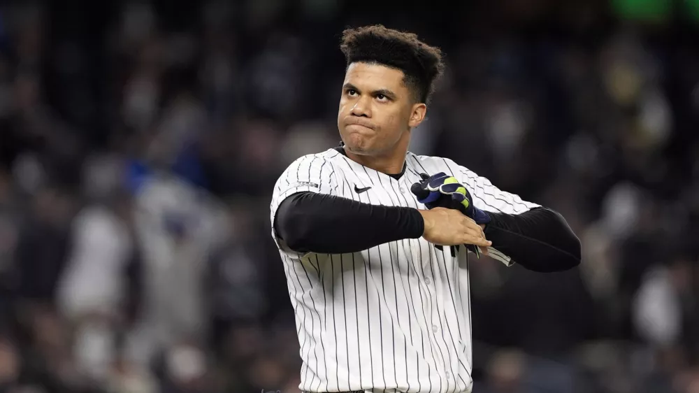 FILE - New York Yankees' Juan Soto takes off his batting gloves after grounding out against the New York Yankees to end the third inning in Game 3 of the baseball World Series, on Oct. 28, 2024, in New York. (AP Photo/Godofredo A. V&aacute;squez, File)