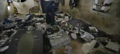 A woman looks at a room of the infamous Saydnaya military prison, just north of Damascus, Syria, Monday, Dec. 9, 2024. Crowds are gathering to enter the prison, known as the "human slaughterhouse," after thousands of inmates were released following the rebels' overthrow of Bashar al-Assad's regime on Sunday. (AP Photo/Hussein Malla)