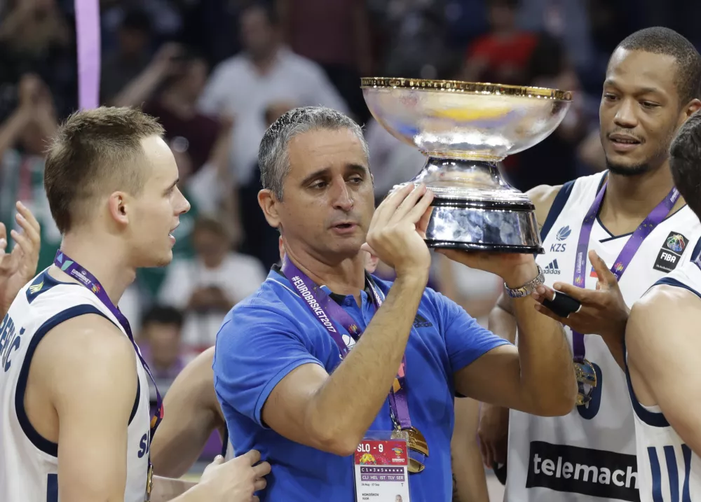 Slovenia's coach Igor Kokoskov, center, holds the trophy and celebrates after winning the Eurobasket European Basketball Championship final match against Serbia, in Istanbul, Sunday, Sept. 17. 2017. (AP Photo/Lefteris Pitarakis)