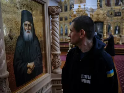 A recovering Ukrainian soldier looks at the icon of a saint inside the church of the Skete of Prophet Elijah in Mount Athos, Greece, November 26, 2024. In their four-day stay, part of a psychological support programme organised by Ukrainian authorities, the 22 soldiers made a pilgrimage to some dozen monasteries on the slopes of Mount Athos, a spiritual centre since the 10th century. "A lot of servicemen suffer from the events that took place over the last three years. A lot of them suffer from different illnesses &ndash; they are wounded, and we have to rehabilitate them," said Father Mykhailo Pasirskyi, a Ukrainian Orthodox priest. REUTERS/Alexandros Avramidis     SEARCH "AVRAMIDIS UKRAINE ATHOS" FOR THIS STORY. SEARCH "WIDER IMAGE" FOR ALL STORIES.