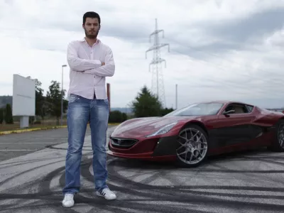 Mate Rimac owner of Rimac Automobili poses with the Concept One car in Zagreb August 31, 2012. Croatian concept car manufacturer Rimac Automobili based near Zagreb prepares to unveil a prototype of their Concept One electric supercar at the upcoming Salon Priv&eacute; car show in London in early September.The Concept One has a carbon fiber body an electric motor powering each wheel, and can produce 1,088 horse powers, capable of achieving top speed of around 305 kmh (190 mph) with a range of 600 kilometres (373 miles), making it the world's fastest electric car. Costing around  million each, only 13 of these high-end electric cars are expected to be produced per year. Picture taken August 31, 2012. REUTERS/Antonio Bronic (CROATIA - Tags: TRANSPORT BUSINESS) - RTR37CTI