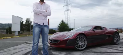 Mate Rimac owner of Rimac Automobili poses with the Concept One car in Zagreb August 31, 2012. Croatian concept car manufacturer Rimac Automobili based near Zagreb prepares to unveil a prototype of their Concept One electric supercar at the upcoming Salon Privé car show in London in early September.The Concept One has a carbon fiber body an electric motor powering each wheel, and can produce 1,088 horse powers, capable of achieving top speed of around 305 kmh (190 mph) with a range of 600 kilometres (373 miles), making it the world's fastest electric car. Costing around  million each, only 13 of these high-end electric cars are expected to be produced per year. Picture taken August 31, 2012. REUTERS/Antonio Bronic (CROATIA - Tags: TRANSPORT BUSINESS) - RTR37CTI