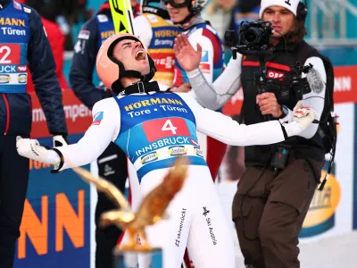 04 January 2025, Austria, Innsbruck: Austria's Stefan Kraft (R) celebrates victory after the men's Large Hill Tournament at the FIS&nbsp;Ski Jumping World Cup. Photo: Daniel Karmann/dpa