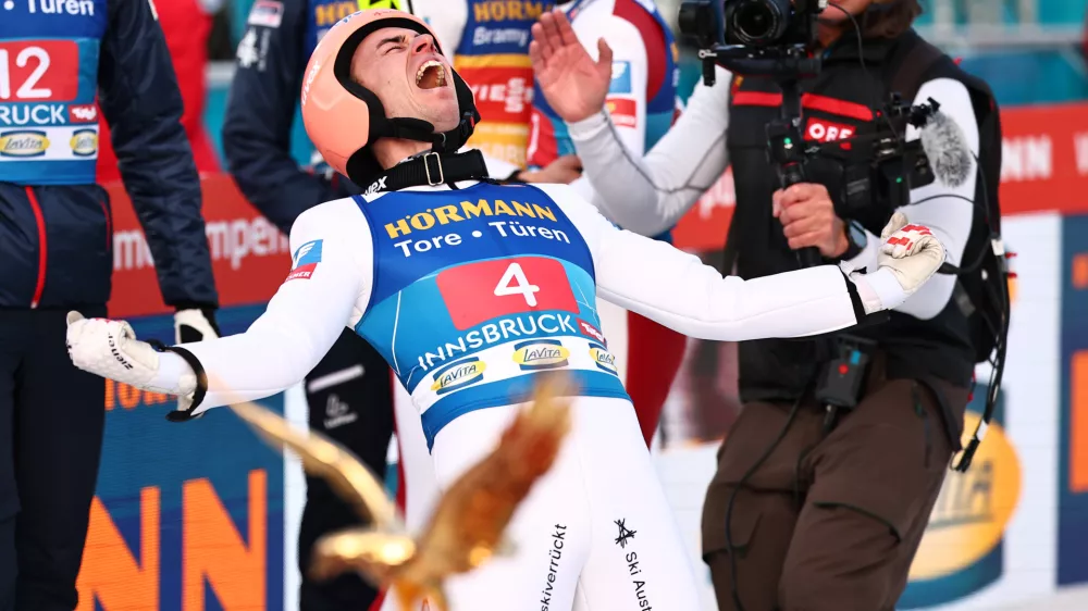 04 January 2025, Austria, Innsbruck: Austria's Stefan Kraft (R) celebrates victory after the men's Large Hill Tournament at the FIS&nbsp;Ski Jumping World Cup. Photo: Daniel Karmann/dpa