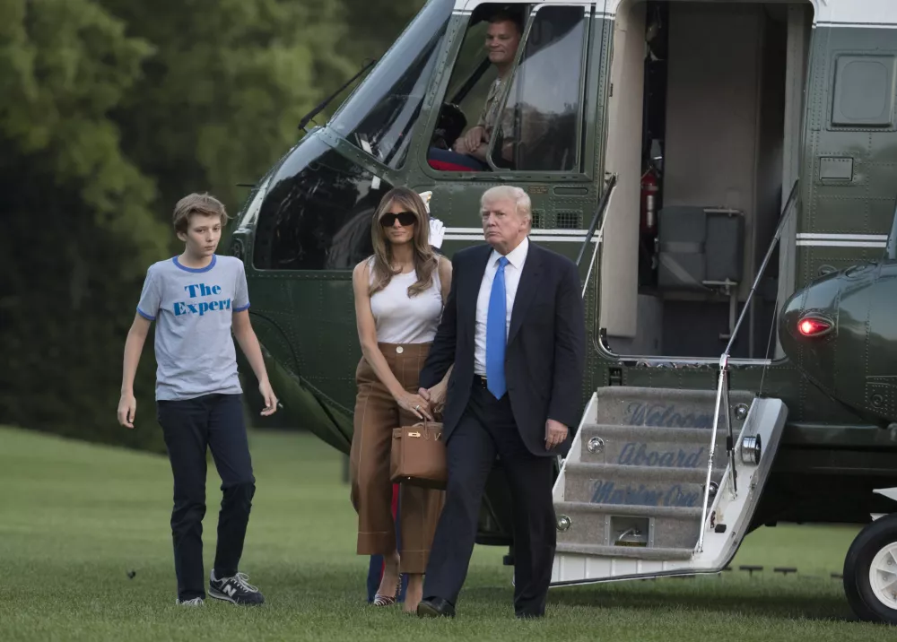 President Donald Trump, first lady Melania Trump, and their son, Barron Trump, walk from Marine One across the South Lawn to the White House in Washington, Sunday, June 11, 2017, as they returned from Bedminster, N.J. (AP Photo/Carolyn Kaster)