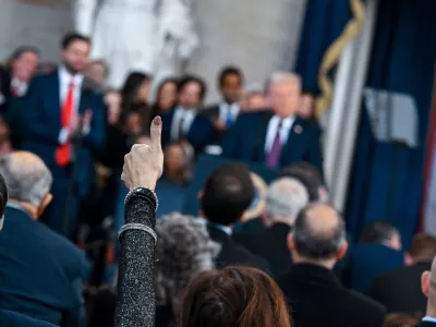 A supporter raises their hand while U.S. President Donald Trump speaks during the inauguration of Donald Trump as the 47th president of the United States takes place inside the Capitol Rotunda of the U.S. Capitol building in Washington, D.C., Monday, January 20, 2025. It is the 60th U.S. presidential inauguration and the second non-consecutive inauguration of Trump as U.S. president. Kenny Holston/Pool via REUTERS