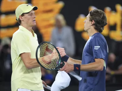 Jannik Sinner, left, of Italy is congratulated by Alex de Minaur of Australia following their quarterfinal match at the Australian Open tennis championship in Melbourne, Australia, Wednesday, Jan. 22, 2025. (AP Photo/Vincent Thian)