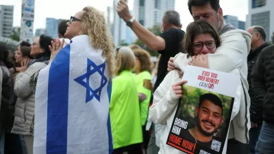 People react as they watch broadcasts related to the release of Israeli hostages, who have been held in Gaza since the deadly October 7, 2023 attack by Hamas, as part of a prisoner-hostage exchange deal between Israel and Hamas, at a public square dedicated to hostages in Tel Aviv, Israel, January 25, 2025. REUTERS/Nir Elias