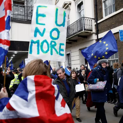 Pro-Brexit supporters celebrate Britain leaving the EU on Brexit day as anti-Brexit demonstrators are seen walking in the opposite way in London, Britain January 31, 2020. REUTERS/Henry Nicholls - RC23RE91JZAV