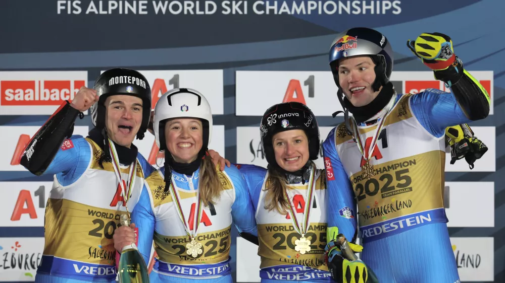 04 February 2025, Austria, Saalbach-Hinterglemm: (L-R) Italian alpine ski racers Filippo Della Vite, Lara Della Mea, Giorgia Collomb and Alex Vinatzer celebrate on the podium after winning the Mixed Parallel final at the FIS Alpine World Ski Championships in Saalbach. Photo: Jens B&uuml;ttner/dpa