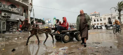 Palestinians make their way along a road on a rainy day, amid a ceasefire between Israel and Hamas, in Gaza City February 6, 2025. REUTERS/Dawoud Abu Alkas