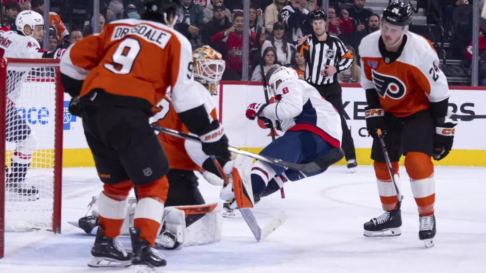Washington Capitals' Alex Ovechkin, center right, gets the puck past Philadelphia Flyers' Ivan Fedotov, center left for a goal, during the first period of an NHL hockey game, Thursday, Feb. 6, 2025, in Philadelphia. (AP Photo/Chris Szagola)