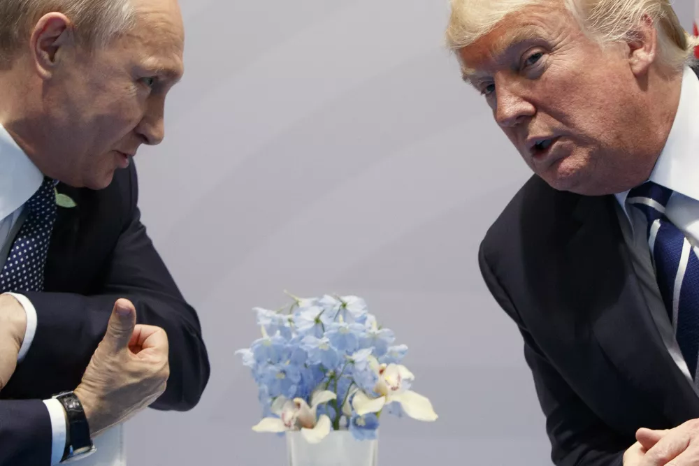 FILE &ndash; Then-U.S. President Donald Trump, right, meets with Russian President Vladimir Putin at the G20 Summit in Hamburg, Germany, Friday, July 7, 2017. (AP Photo/Evan Vucci, File)