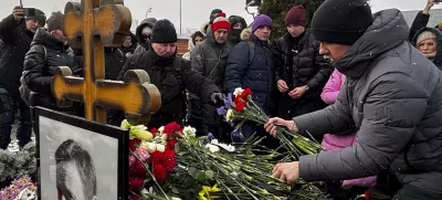 People lay flowers at the grave of Russian opposition leader Alexei Navalny, a year after his death, at the Borisovskoye Cemetery in Moscow, on Sunday, Feb. 16, 2025. (AP Photo)